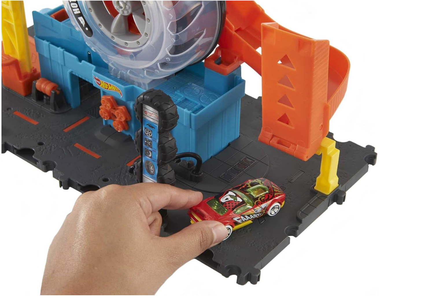 Hot Wheels City Super Twist Tire Shop - Juego de tienda de neumáticos con giro de llave para hacer viajar los autos a través de los neumáticos, incluye 1 auto, regalo para niños de 4 a 8 años