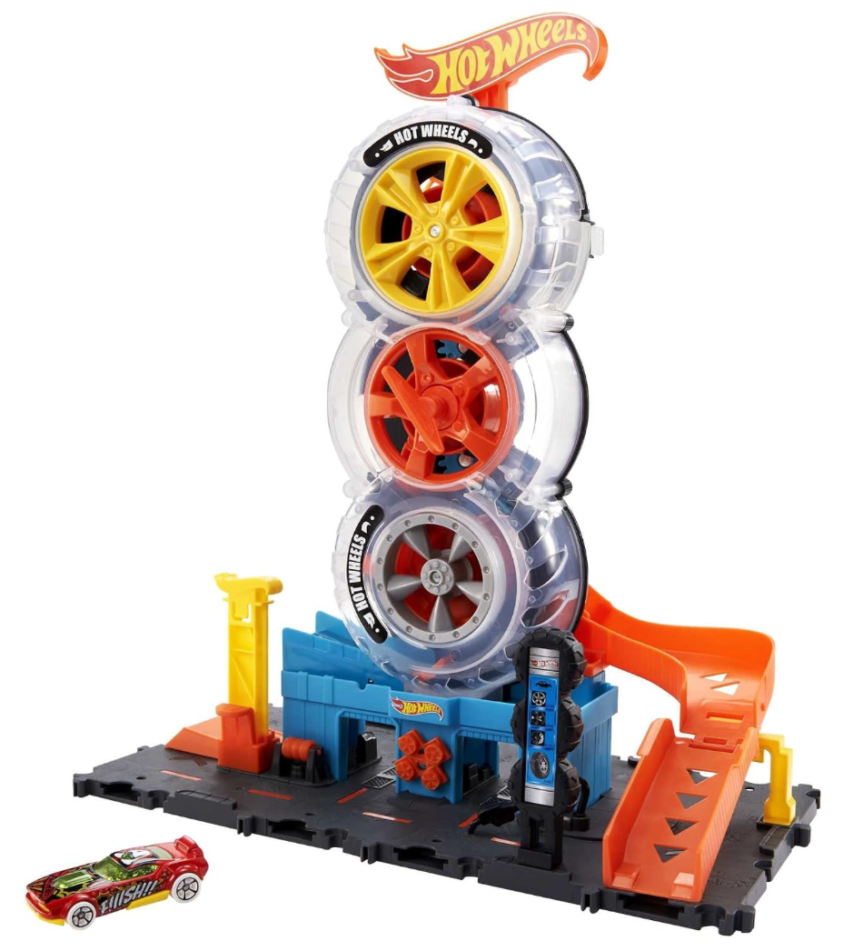 Hot Wheels City Super Twist Tire Shop - Juego de tienda de neumáticos con giro de llave para hacer viajar los autos a través de los neumáticos, incluye 1 auto, regalo para niños de 4 a 8 años